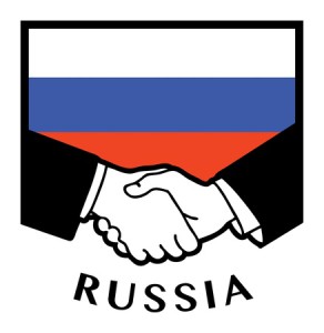  Russian business handshake with Russian flag in the background